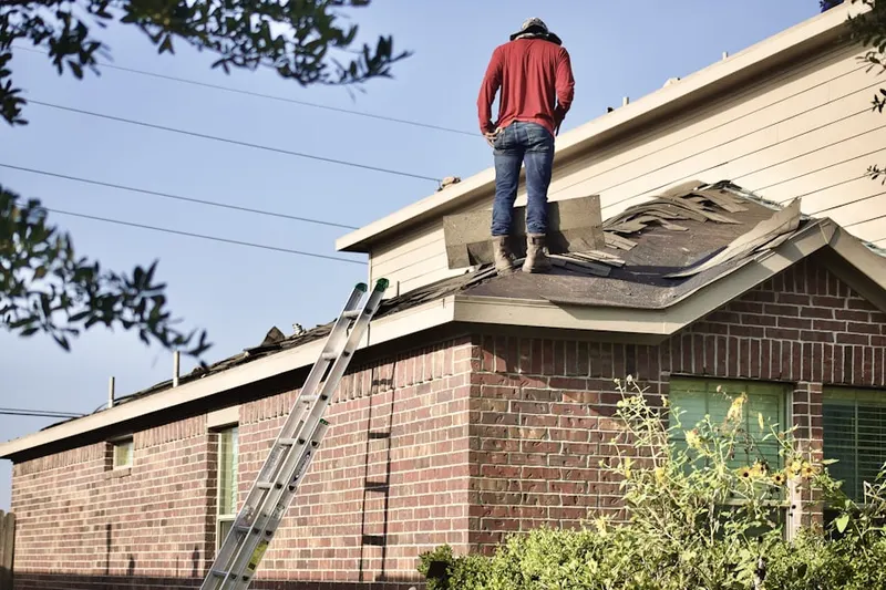 Professional roofer working on a residential roof in Piscataway